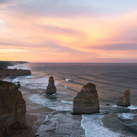 Twelve Apostles sea stacks glowing at sunrise, Port Campbell National Park on Victoria's Great Ocean Road