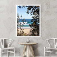 White framed beach photography print of Ulladulla's turquoise wave, framed by banksia trees, Australian coastal wall art