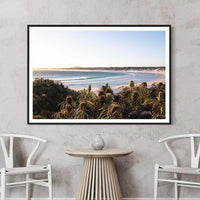 Black framed Wharton Beach print, bold contrast against the turquoise wave and pale sand