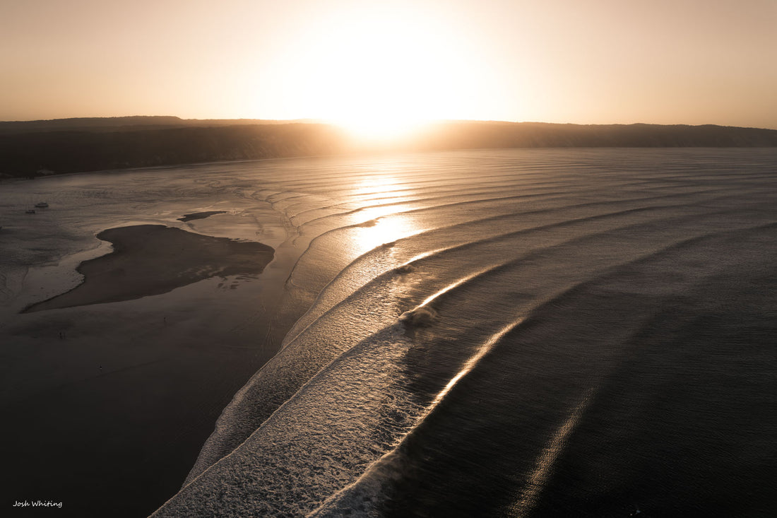 Perfect swell lines wrap around Double Island Point, one of Australia's most famous right hand breaks, shot at Rainbow Beach