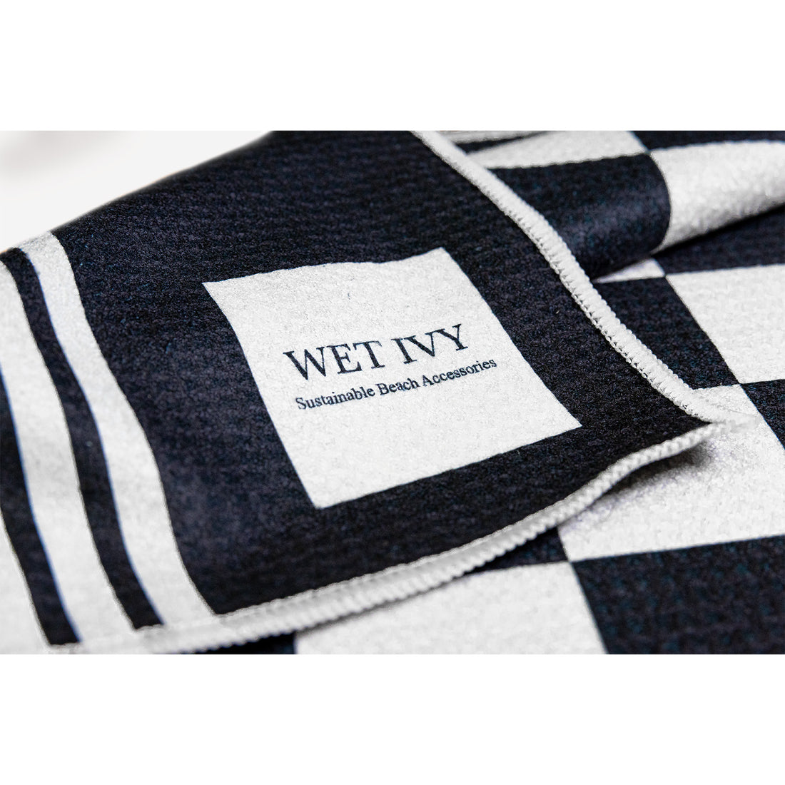 sand free beach towels - towels for sale - wet ivy sustainable beach accessories - travel towels - towels for camping - black and white checkered towels - swimming towels - pool towels - lightweight travel towels - quick dry microfiber towels - antimicrobial towels