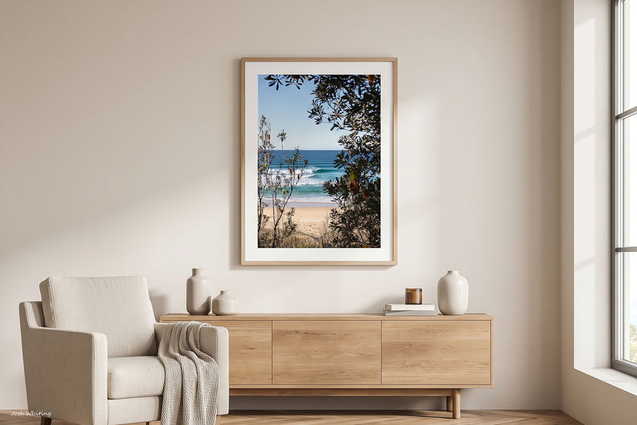 Coastal wall art print, turquoise wave breaking at Ulladulla, NSW South Coast, photographed through banksia trees and native coastal scrub