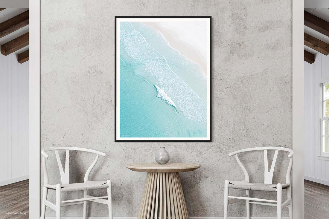 Black framed Open Coast print, bold contrast against the turquoise water and pale sand