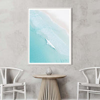 White framed print of Open Coast showing turquoise ocean and pale sand from above, coastal wall art for relaxed interiors
