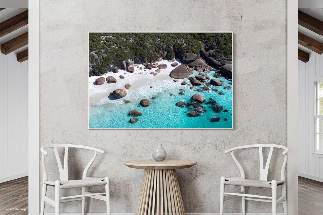 White floating frame canvas print of a secluded cove, ocean wall art suited to coastal and Hamptons style interiors