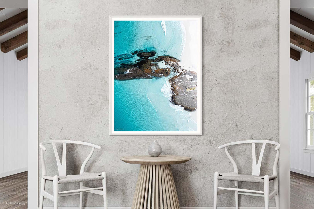 White framed abstract print of swirling turquoise water, portrait Australian wall art