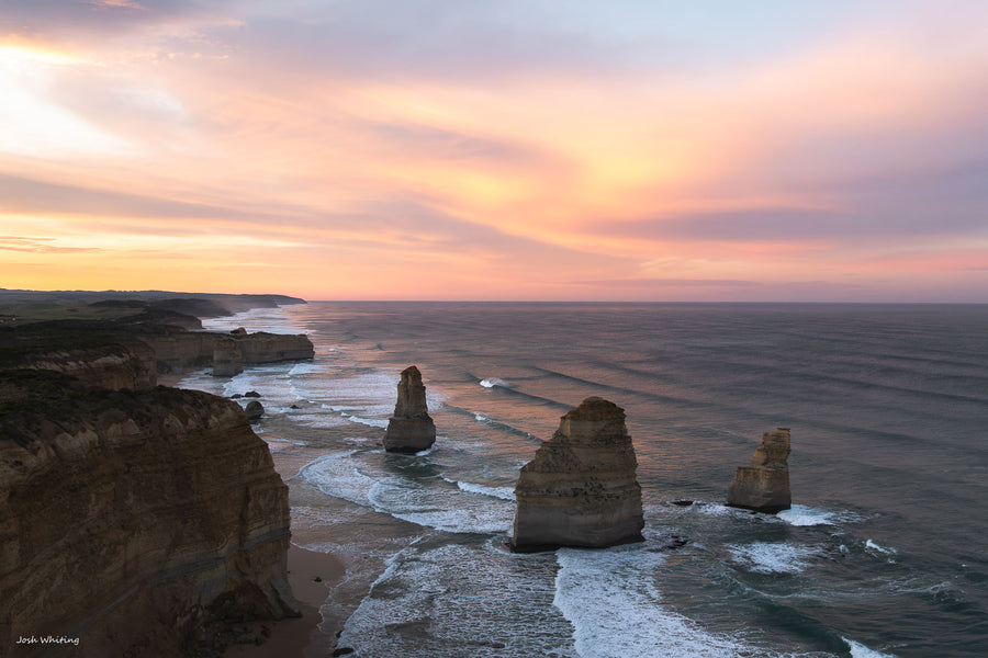 Twelve Apostles sea stacks glowing at sunrise, Port Campbell National Park on Victoria's Great Ocean Road